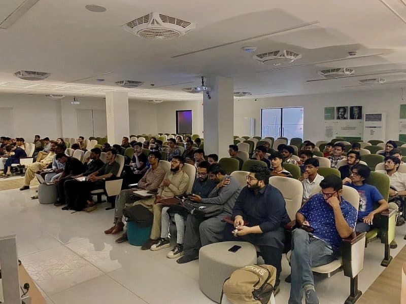 A hall full of students listening during one of the sessions, every seat taken.